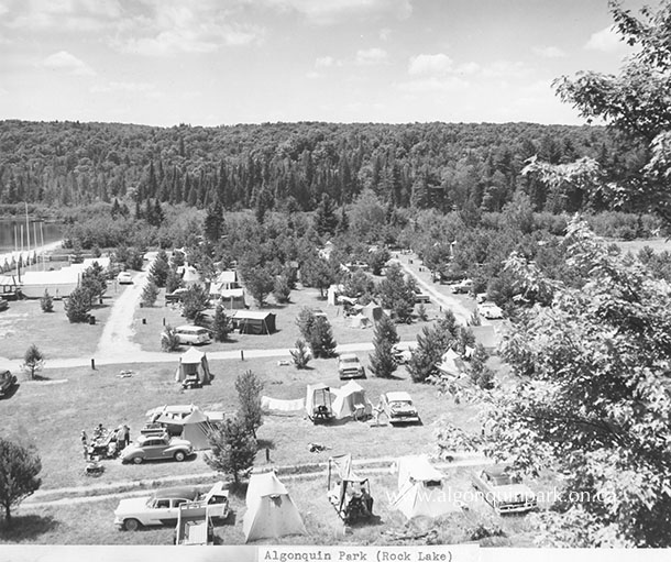 Image: The construction of Highway 60 paved the way for the boom of car camping and campground Algonquin Park experienced in the 1950s and 1960s. High view of Rock Lake Campground, 1958. APPAC, APM 713.