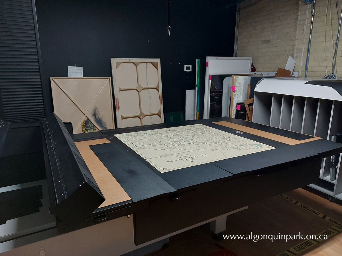 Preparing a large format map from the APPAC for high resolution scanning. Digitization funded by The Friends of Algonquin Park.