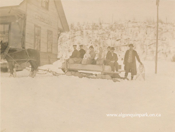 Image: A sleighing party outside Canoe Lake station, Christmas Day, 1913. Local residents and visitors from nearby communities have gathered to celebrate the holiday. APPAC, 1972.3.29, Thomas & Wilkinson Collection.