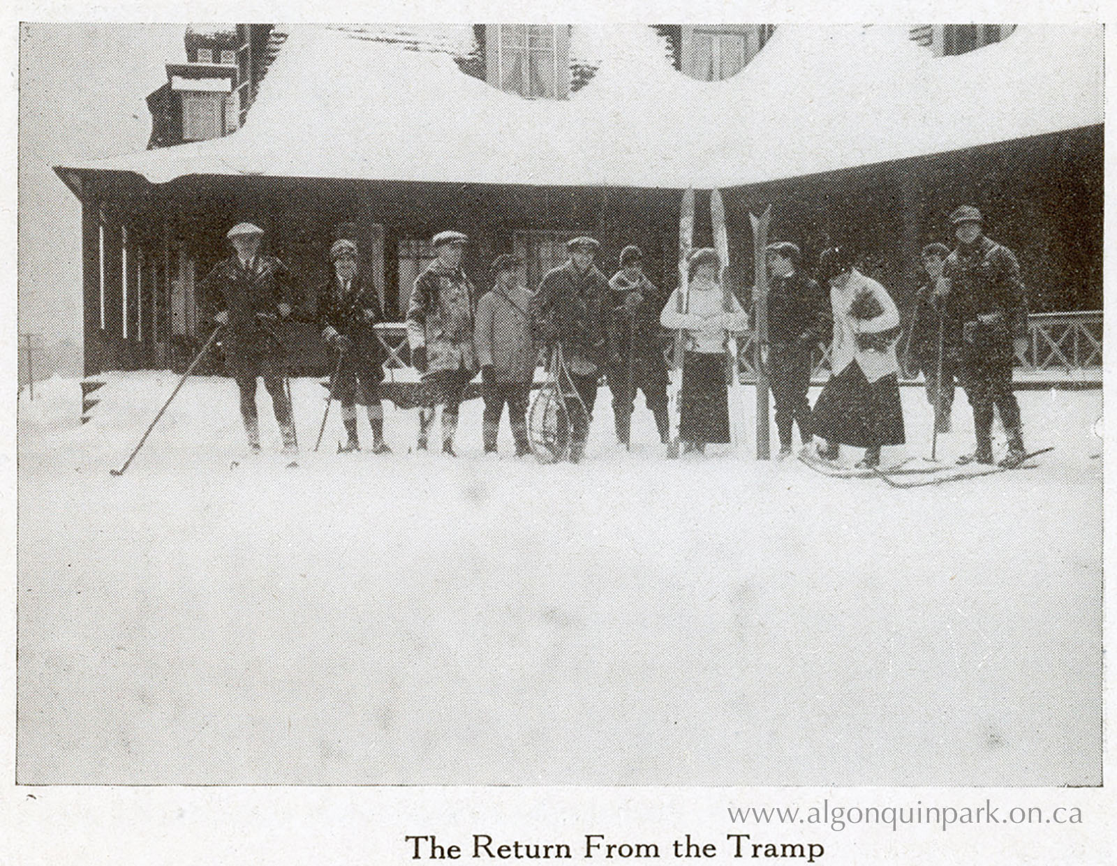 Image: Guests stand outside the Highland Inn in winter clothing with snowshoes, skis, and poles. “The Return From The Tramp”, in “Enjoy Winter in Ontario Highlands: Algonquin Park Ontario Canada”, 1921-1922. APPAC, 1977.9.1.1, From the Collection of Dr. Duncan A. MacLulich, Donated by M.A. Capstick. 