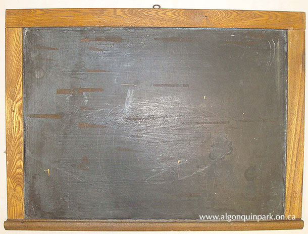 A small chalkboard, 61.2 cm x 45 cm x 4 cm, used at the Cache Lake Schoolhouse, c. 1940s. 